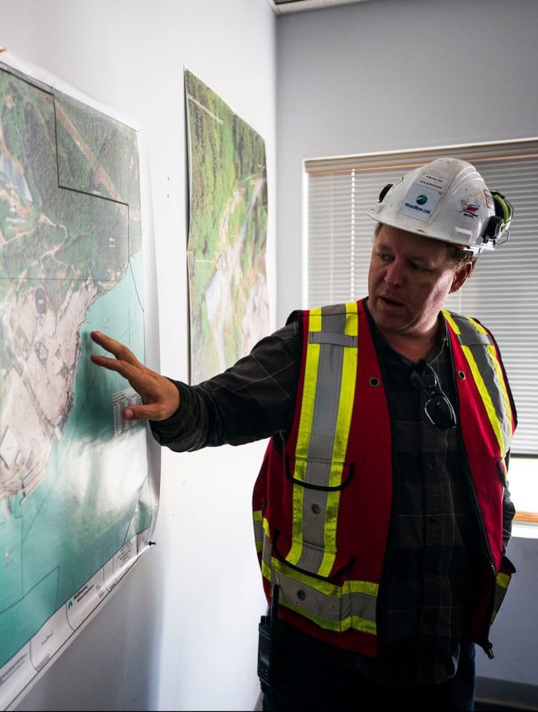 Site visit at Woodfibre near Squamish, BC, worker pointing at map